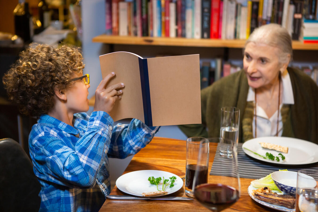 Little Boy Pointing to the Haggadah at Passover Seder