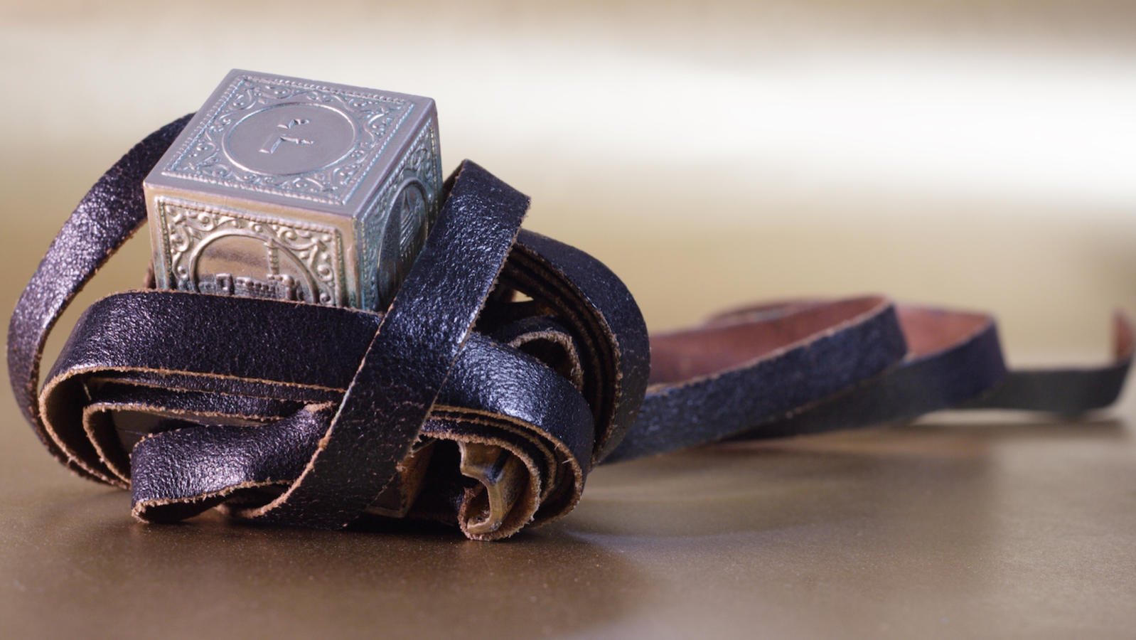 Tefillin, called phylacteries in English, contain scrolls with versus , tefillin