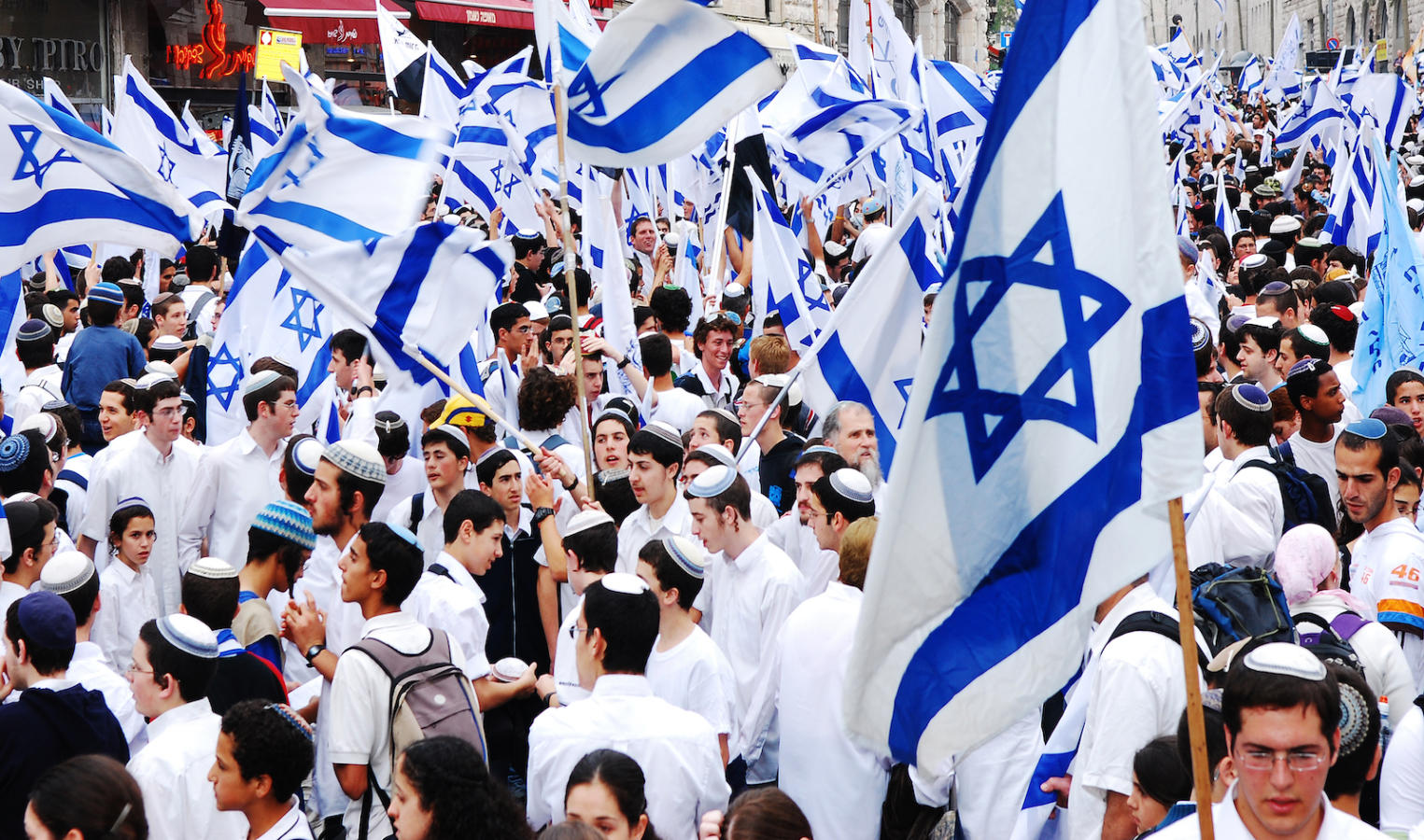 Jerusalem, Israel- April 14, 2007: Young people gathering with flags of Israel at Jaffa Street in the center of Jerusalem to celebrate Israel's Independence Day.