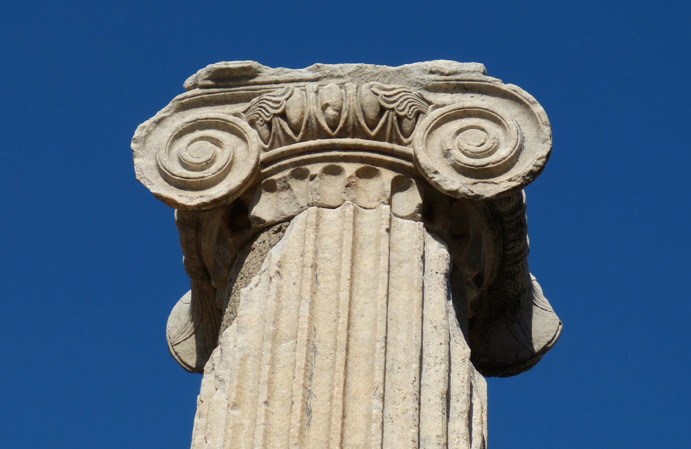 top of an ancient column against a blue sky