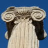 top of an ancient column against a blue sky