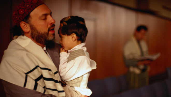 Jewish Man Holding Son and Praying