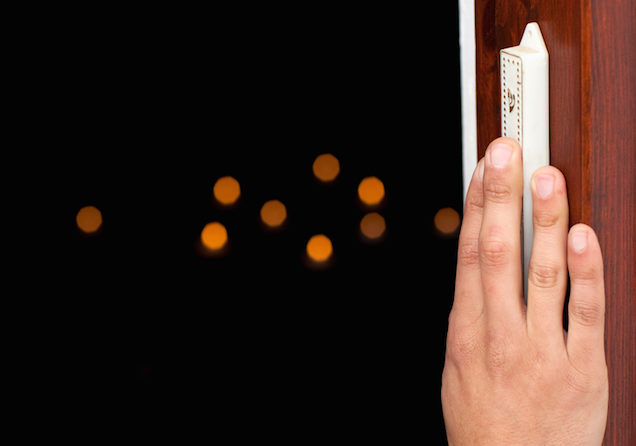 "Jew entering to the dark room, touching and kissing the Mezuzah (guardian of Israel's doors)."