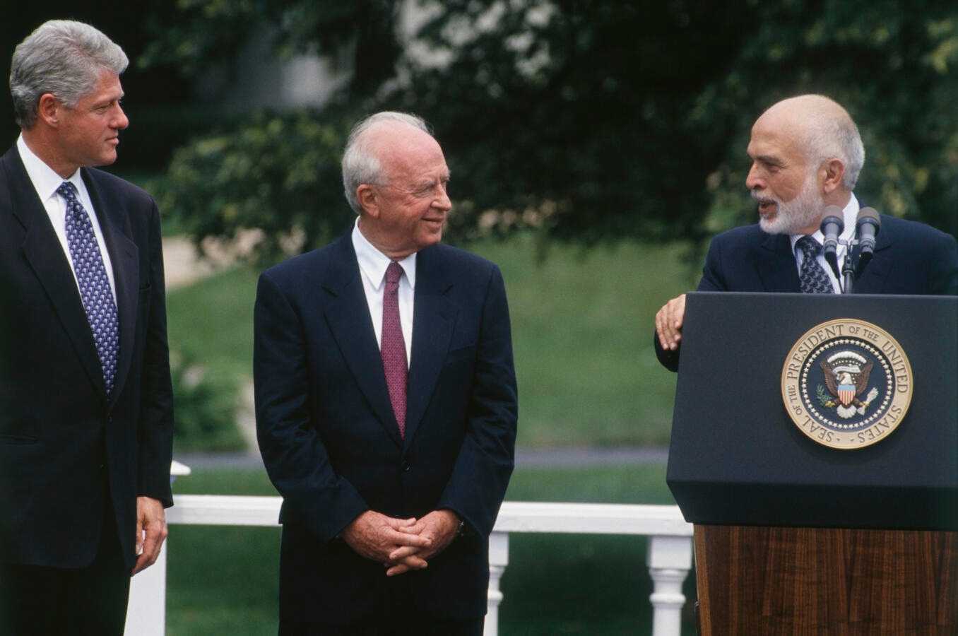 Three men on the lawn of the White House.