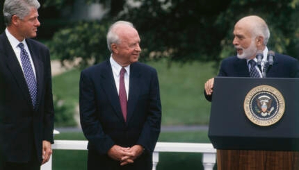 Three men on the lawn of the White House.