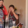 Jewish girl and mother cover eyes to recite Shabbat blessing