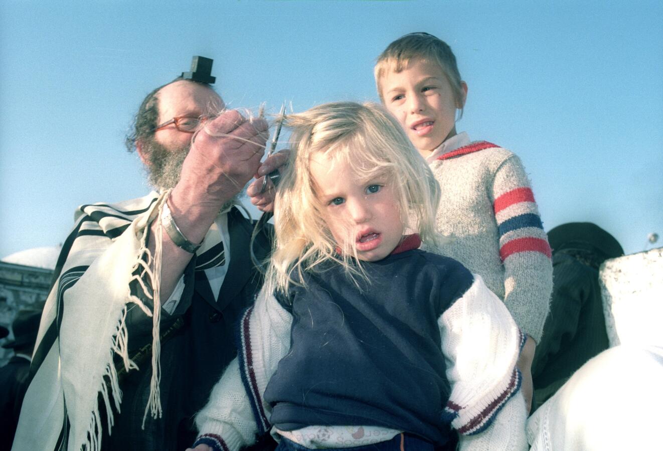 picture of a jewish boy having his hair cut for the first time