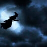 Witch flying on broom silhouetted against the moon.