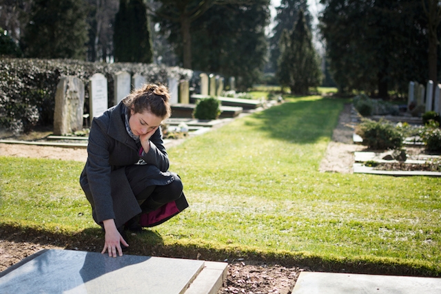 Woman sitting at grave