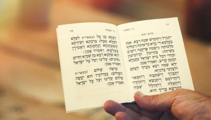 man holding kaddish prayer