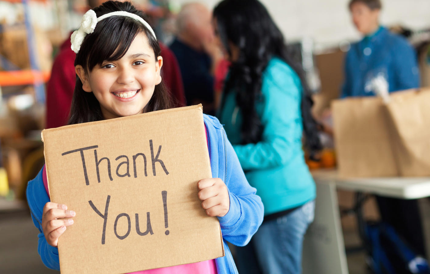 Adorable little girl holds thank you <a href=