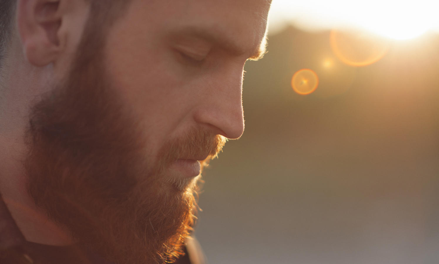 young bearded man with eyes closed