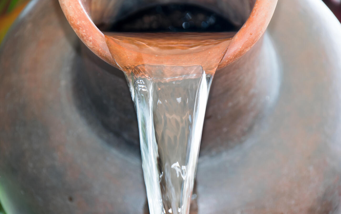 Close up Pour water out of terracotta pots.