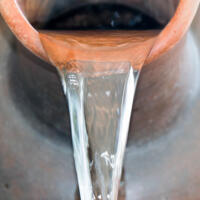 Close up Pour water out of terracotta pots.