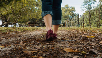 Woman Walking on Dirt Trail at Sabandar Beach, Tuaran, Sabah.