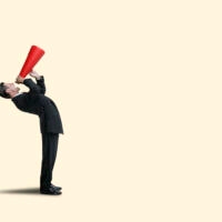 A businessman bends over backward as he shouts into a red megaphone isolated against a yellow background.