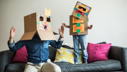 Father and daughter wearing robot costumes at home