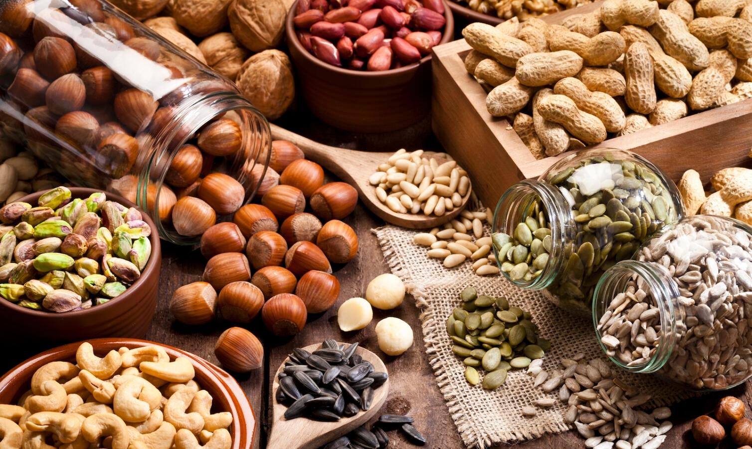 Assortment of nuts on rustic wood table.