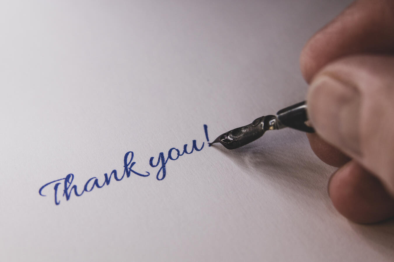 Close-up of a hand from a person writing thank you with a Fountain pen.