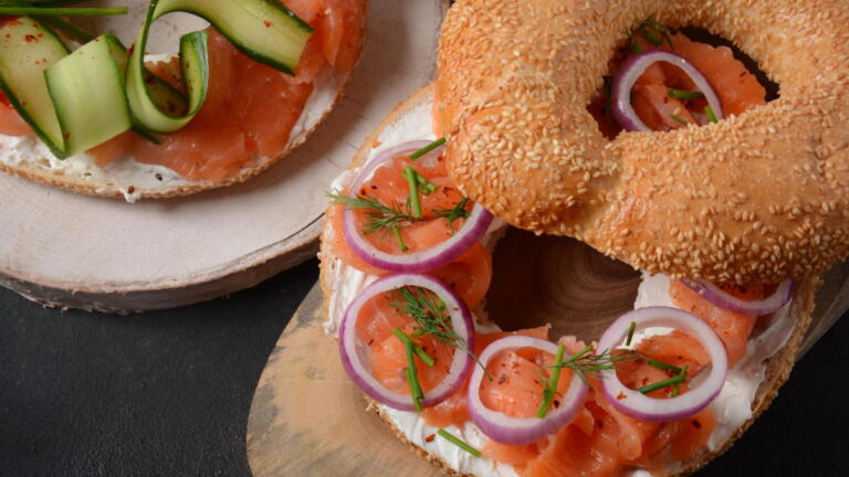 Bagel sandwich with salmon, cream cheese, cucumber, and onions flagel flat bagel